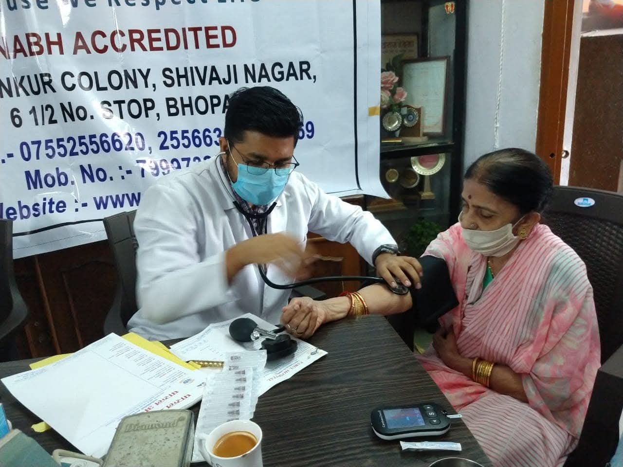 Doctor consultation with elderly patient at community health camp